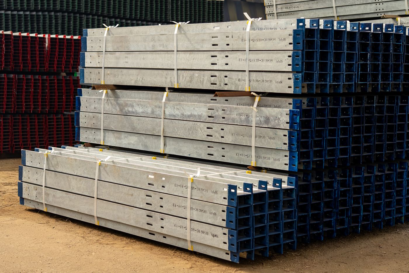 Long steel profiles stacked in an industrial materials yard